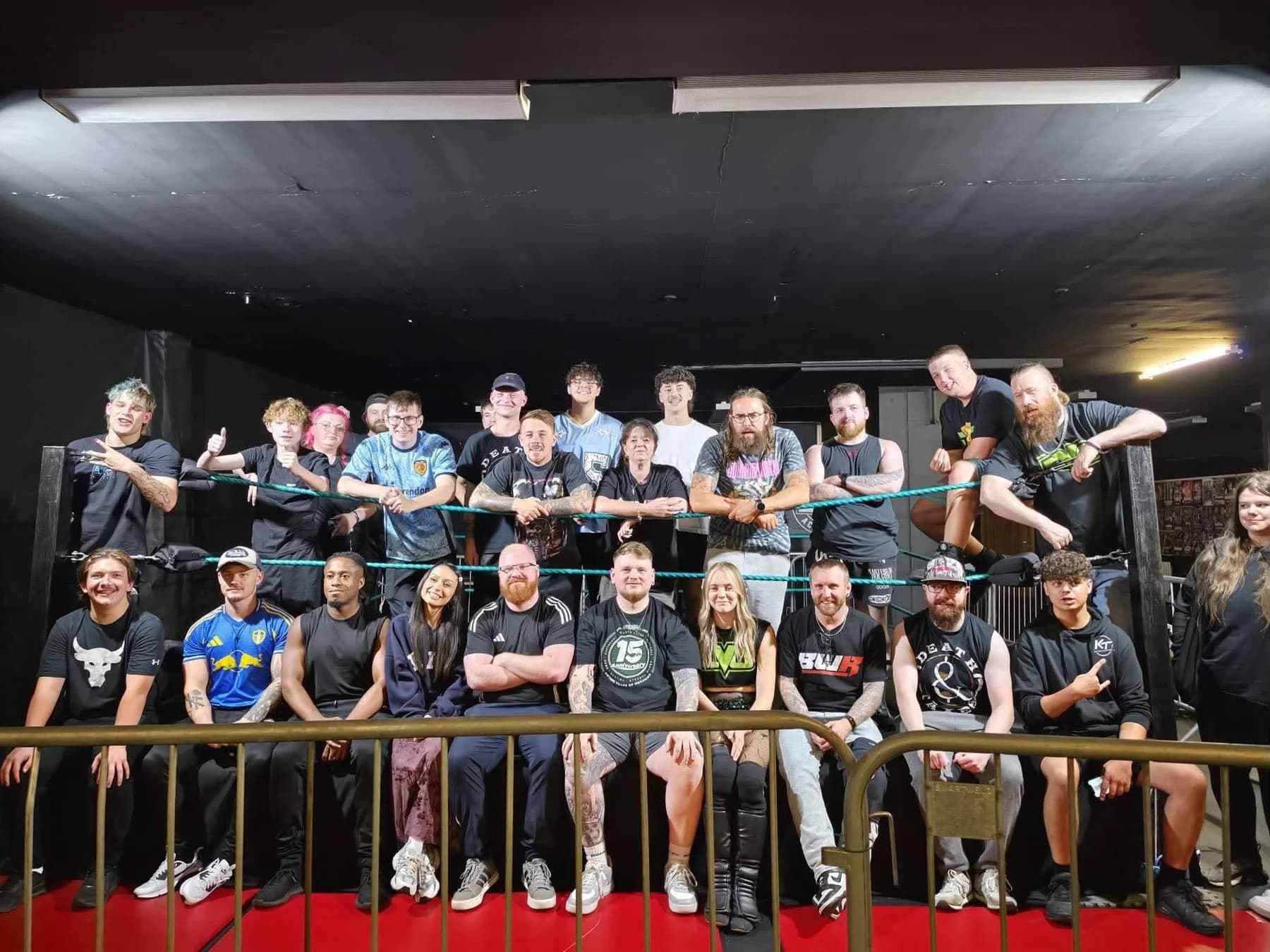 EVO members gathered together in and around the wrestling ring